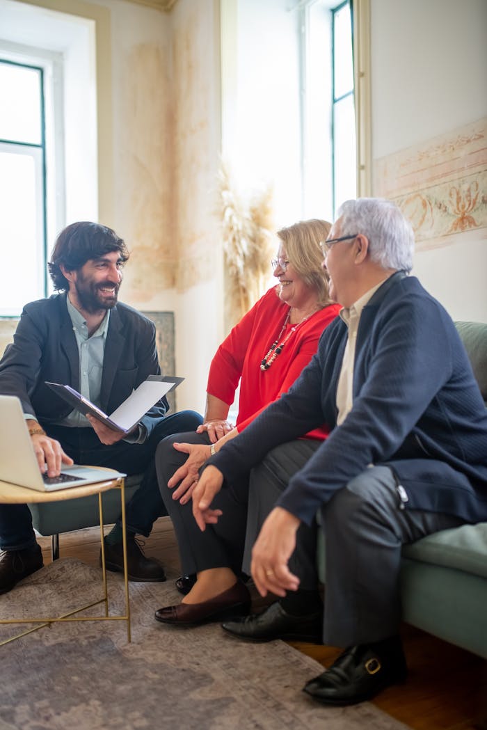 services-img A professional business consultation with a senior couple and advisor indoors.