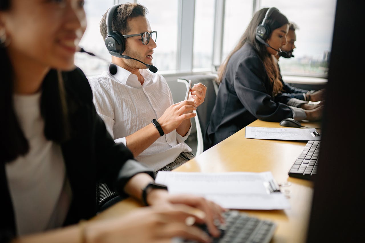gallery-1 A diverse team of call center agents working together in a modern office setting.